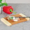 A red bell pepper and a slice of bread with cream cheese and dill on a wooden cutting board. Anteprima dell’immagine prodotto