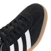 A close-up view of the toe and side of a black Adidas sneaker with white stripes and a tan sole. Produktbild-Vorschau