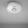 A white smoke detector is mounted on a textured light gray ceiling. Produktbild-Vorschau