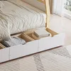 Close-up view of a bed with storage drawers, showing folded blankets and a book. Anteprima dell’immagine prodotto