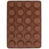 A top-down view of a brown silicone baking mold filled with chocolate candies. Voir les images du produit