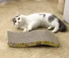 A cat is lying on a carpet next to a cardboard scratching pad. Voir les images du produit