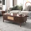 A living room scene with a coffee table in the foreground and a sofa in the background. Voir les images du produit