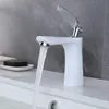 A white bathroom faucet with water running into a sink, with a bar of soap and a towel in the background. Náhled obrázku produktu