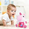 A baby crawling on a carpet next to a plush unicorn toy. Anteprima dell’immagine prodotto