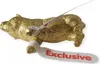 A golden pig figurine with tags attached. Produktbild-Vorschau