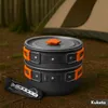 Camping cookware set with cutlery in a forest setting with a tent in the background. Náhled obrázku produktu