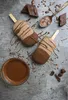 Chocolate ice cream bars and chocolate sauce on a textured gray surface. Produktbild-Vorschau