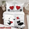 A bedding set with a teddy bear couple kissing design, displayed on a bed. Produktbild-Vorschau