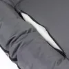 A close-up view of a gray dog bed with a zipper partially open, revealing white padding. Produktbild-Vorschau