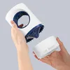 Two hands are shown assembling or disassembling a white and blue insect lamp. Produktbild-Vorschau