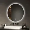 A round LED mirror is mounted on a tiled wall above a sink in a modern bathroom. Anteprima dell’immagine prodotto