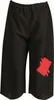 A pair of black pants with a red patch on the right leg. Produktbild-Vorschau