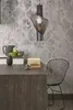A kitchen counter with a pendant light, a basket of apples, a coffee cup, and a chair. Produktbild-Vorschau
