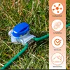 A close-up of a waterproof cable connector for a robotic lawnmower, placed in grass. The connector is blue and white, with a green cable inserted. To the right, there are four circular icons with text describing product features. Produktbild-Vorschau