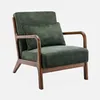 A green armchair with wooden legs and armrests, placed on a white background. Produktbild-Vorschau