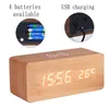 A digital alarm clock with a wooden finish, displaying the time and temperature. The image also includes close-up insets showing battery placement and USB charging. Produktbild-Vorschau