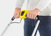 A person's hands holding the handle of a lawnmower. Produktbild-Vorschau