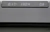 A close-up of a digital display on a black electronic device. Voir les images du produit