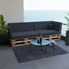 A modern outdoor seating area with a pallet sofa and coffee tables overlooking the ocean. Produktbild-Vorschau