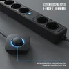 A black power strip with multiple outlets and a separate foot switch with a blue illuminated ring, shown on a gray textured surface. Podgląd zdjęcia produktu