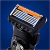 Close-up of a razor head with multiple blades and an orange lubrication strip. Produktbild-Vorschau