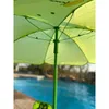 Close-up view of the underside of a green umbrella with a cartoonish yellow design, near a blue swimming pool. Produktbild-Vorschau