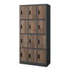 A tall metal locker with 12 compartments, each with a wood-grain finish door and a black handle. Anteprima dell’immagine prodotto