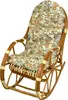 A rattan rocking chair with a floral cushion, isolated on a white background. Produktbild-Vorschau