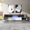 A modern TV cabinet with open compartments and drawers, illuminated by blue LED lights, displayed in a living room setting with abstract art on the wall. Náhľad obrázku produktu