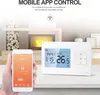 A hand holding a smartphone displaying a thermostat app, with a smart thermostat device on a table in front of a fireplace. Podgląd zdjęcia produktu