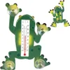 A green frog-shaped thermometer with suction cups is shown against a white background. Another smaller frog is in the background. Voir les images du produit