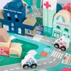 A close-up view of a wooden city building block set with a puzzle play mat and vehicles. Náhled obrázku produktu