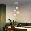 A modern dining room with a pendant light fixture over a table. Produktbild-Vorschau