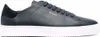 A close-up, side view of a single dark blue sneaker with a white sole. Produktbild-Vorschau
