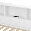 A close-up view of a white headboard with built-in shelves and a power outlet. Produktbild-Vorschau