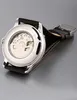 The back of a watch with a clear case showing the internal mechanism. Produktbild-Vorschau