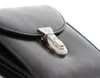 A close-up shot of a black leather wallet with a silver clasp. Produktbild-Vorschau