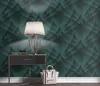A bedside table with a lamp, books, and a handbag, set against a patterned wallpaper. Produktbild-Vorschau