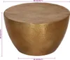 A brass-colored hammered coffee table is shown from a slightly elevated side angle against a white background. Dimensions are indicated with measurement lines and text. Náhled obrázku produktu
