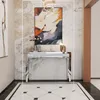A console table with decorative items and artwork in a hallway or living room. Anteprima dell’immagine prodotto