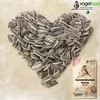 A heart shape made of sunflower seeds with a bag of sunflower seeds in the bottom right corner. Produktbild-Vorschau