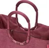A close-up view of the handles and upper portion of a maroon shopping bag. Náhľad obrázku produktu