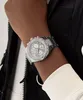A close-up shot of a person's wrist wearing a silver watch. Produktbild-Vorschau