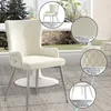 A cream-colored dining chair with silver legs is shown in a room with large windows. Produktbild-Vorschau