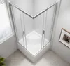 A modern corner shower enclosure with glass doors and silver frames, set against a tiled wall and a light gray floor. Náhľad obrázku produktu