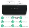The back of a digital alarm clock with feature icons and text labels. Produktbild-Vorschau