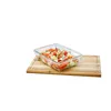 A glass food container filled with chopped vegetables sits on a wooden cutting board. Náhľad obrázku produktu