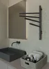 A modern bathroom scene featuring a sink, faucet, mirror, and a towel warmer. Náhľad obrázku produktu