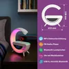 A bedside table with a modern lamp that features a clock, wireless charger, and colorful lighting. The image also includes a diagram of the product with dimensions and feature icons. Náhled obrázku produktu